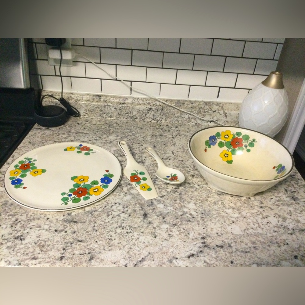 Bowl and platter with serving utensils